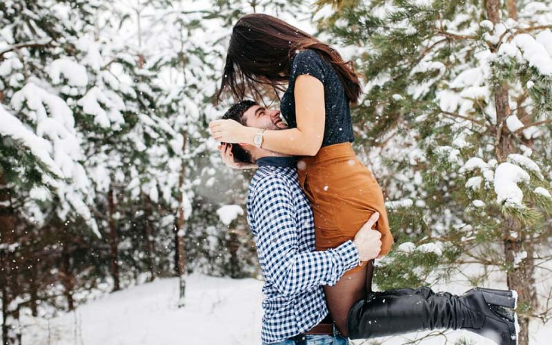 couple posing for a photographer in the snow, Manchester weddings, September 2024, UK