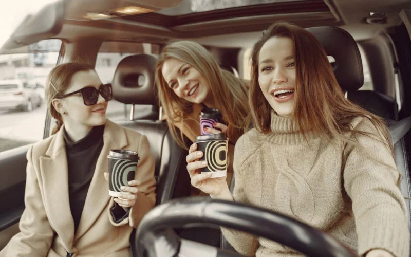 A group of happy holidaymakers boarding a luxury charter bus for a coastal UK getaway.