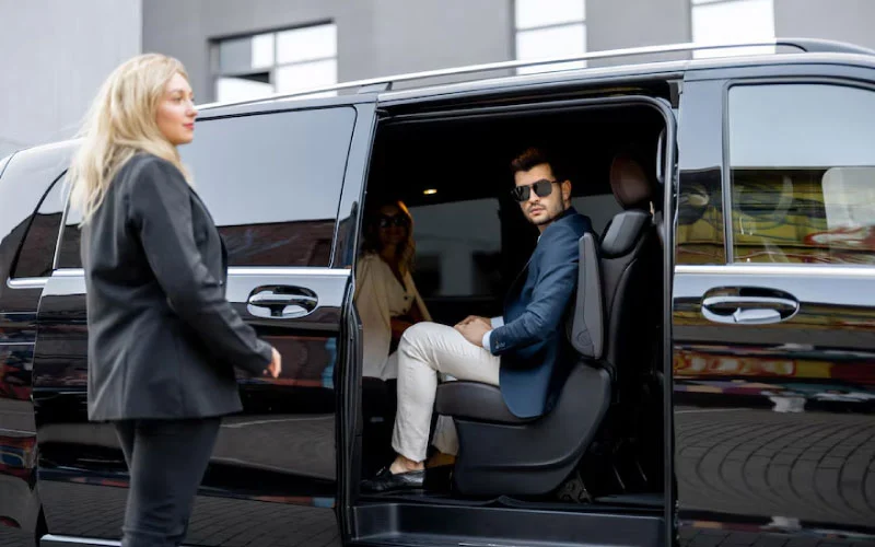 A group of happy holidaymakers boarding a luxury charter bus for a coastal UK getaway.