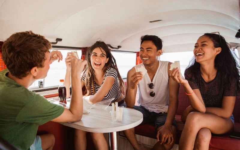 A group enjoying a guided tour on a comfortable tour bus in the UK.