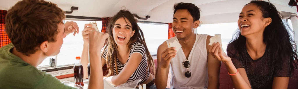 A group enjoying a guided tour on a comfortable tour bus in the UK. UK Tour Bus Services