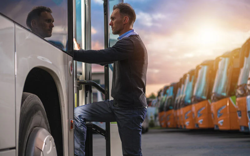 Business team boarding a sleek coach bus for a Manchester corporate trip.