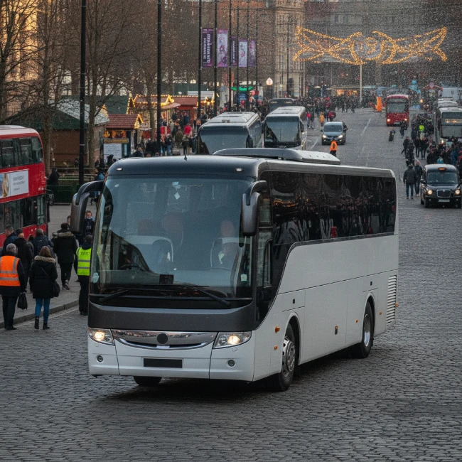 A modern coach parked on a Manchester street, ready for group transport to a festival.